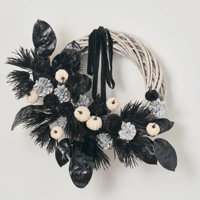 Macabre Magnolia – Black Jagged Pine, Magnolia Leaf with Mini Velvet Pumpkins & Black Velvet Ribbon Asymmetrical Halloween Front Door Mantle Wreath