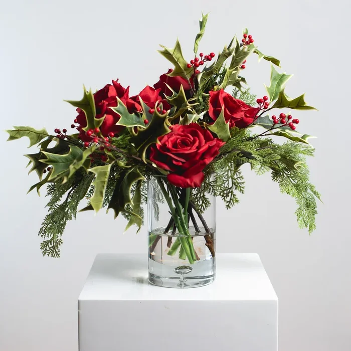 Tis The Season – Red Christmas Rose, Cypress & Holly Holiday Floral Arrangement Centerpiece in Glass Vase