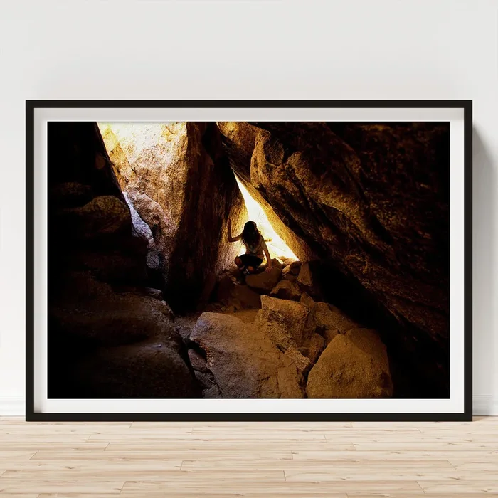 Young Boy Climbing Under Large Boulders Cave Art Print